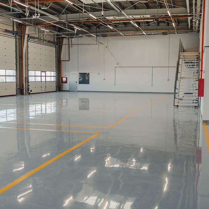 Epoxy and waxed flooring with colorful signage in car service